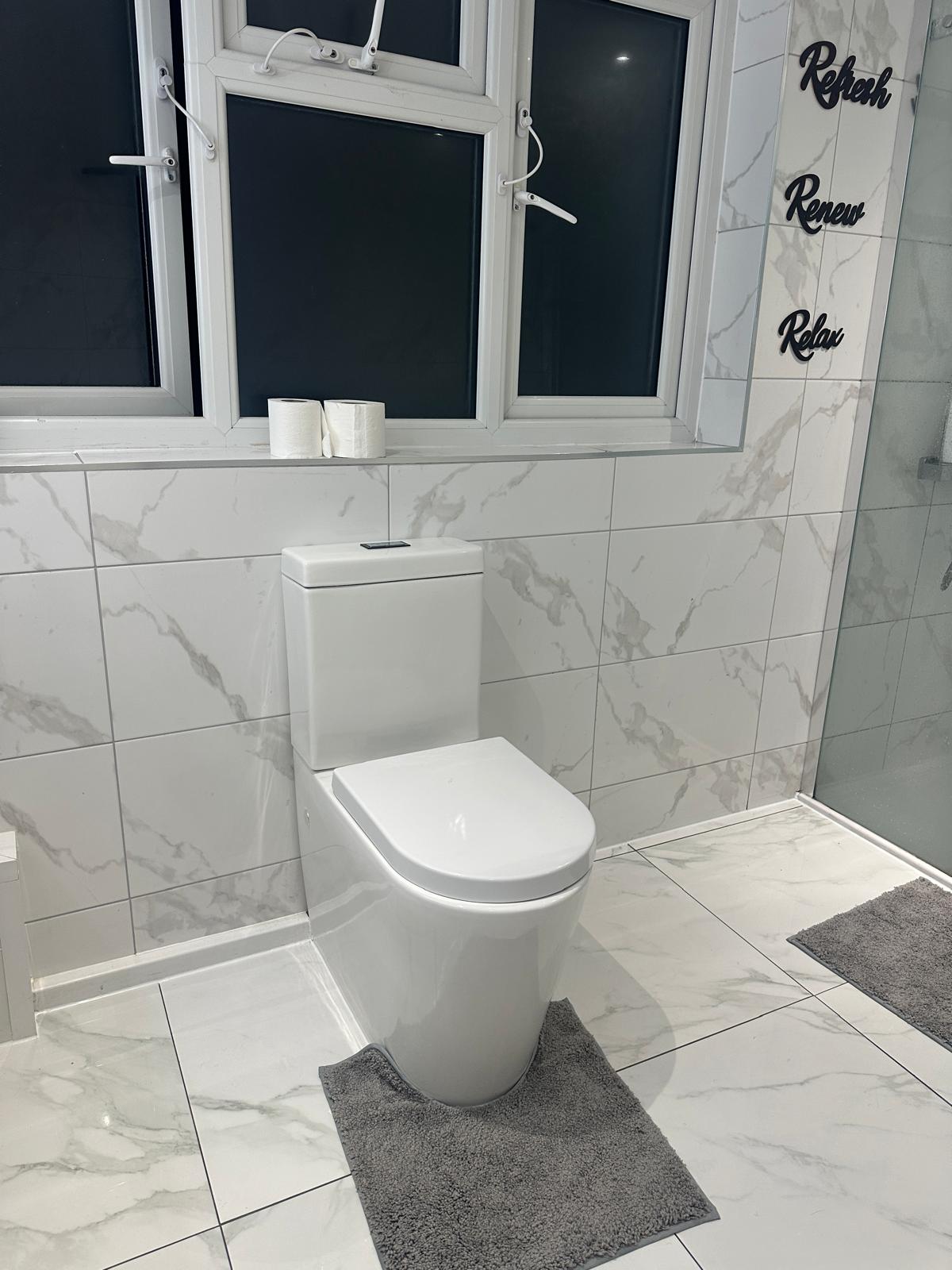 White toilet and tiled floor in the Winter Park bathroom